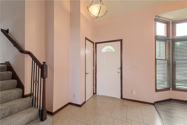 8300 W 148th St, Overland Park, KS 66223 - entrance foyer featuring healthy amount of natural light, stairway, and light tile patterned floors