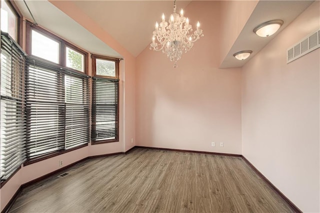 8300 W 148th St, Overland Park, KS 66223 - spare room with wood finished floors, a chandelier, and vaulted ceiling