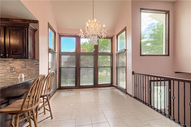 8300 W 148th St, Overland Park, KS 66223 - dining area featuring lofted ceiling, a chandelier, and plenty of natural light