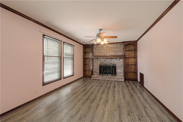 8300 W 148th St, Overland Park, KS 66223 - unfurnished living room with crown molding, ceiling fan, wood finished floors, a brick fireplace, and built in shelves