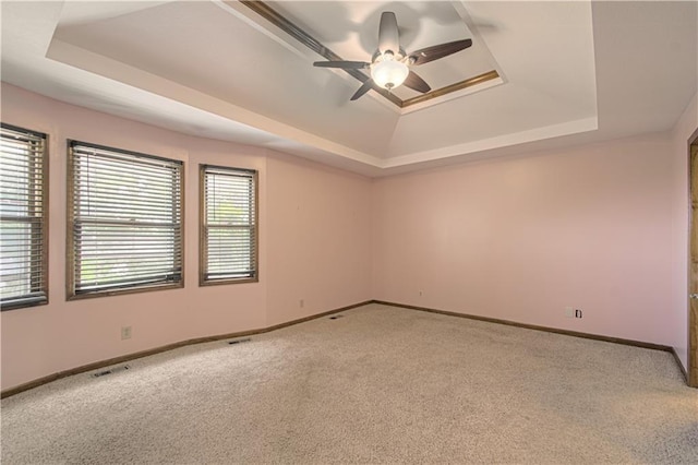 8300 W 148th St, Overland Park, KS 66223 - carpeted spare room featuring a tray ceiling and a ceiling fan