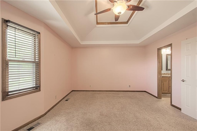 8300 W 148th St, Overland Park, KS 66223 - spare room with a tray ceiling, light colored carpet, and a ceiling fan