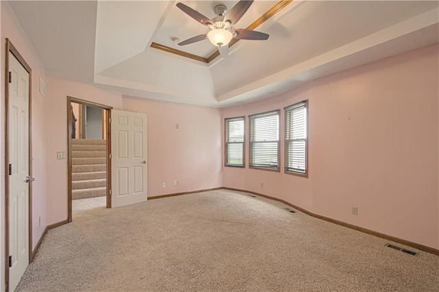 8300 W 148th St, Overland Park, KS 66223 - unfurnished bedroom featuring a tray ceiling, carpet flooring, and ceiling fan
