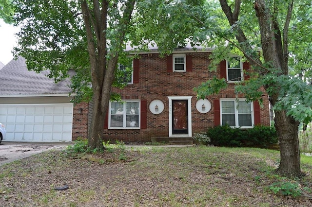 13655 S Sycamore St, Olathe, KS 66062 - view of front of home with brick siding, a garage, and concrete driveway