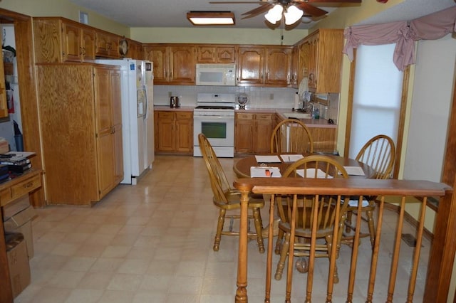 13655 S Sycamore St, Olathe, KS 66062 - kitchen with white appliances, a ceiling fan, light countertops, and light flooring