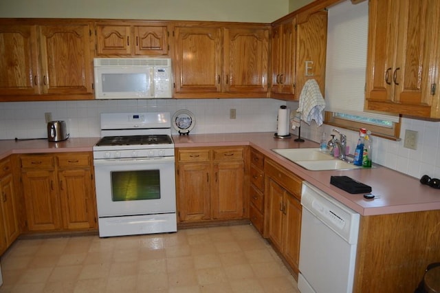 13655 S Sycamore St, Olathe, KS 66062 - kitchen with white appliances, brown cabinets, decorative backsplash, light countertops, and light flooring