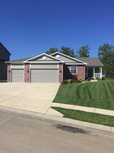 19706 E 20th St N, Independence, MO 64058 - single story home featuring an attached garage, brick siding, a front yard, and concrete driveway