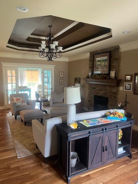 19706 E 20th St N, Independence, MO 64058 - living room with ornamental molding, a tray ceiling, plenty of natural light, and a chandelier