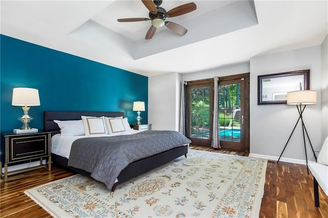 5490 W 85th Ter, Prairie Village, KS 66207 - bedroom featuring a raised ceiling, access to exterior, wood finished floors, and a ceiling fan