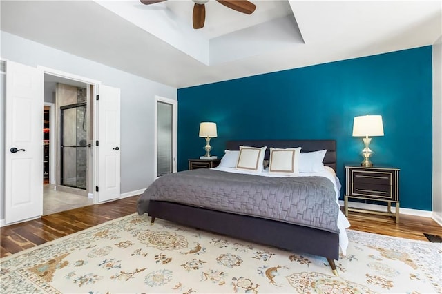 5490 W 85th Ter, Prairie Village, KS 66207 - bedroom featuring wood finished floors, a raised ceiling, and ceiling fan