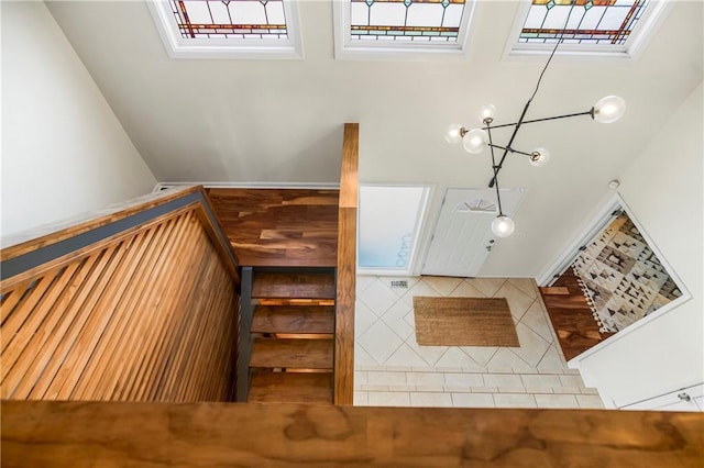 5490 W 85th Ter, Prairie Village, KS 66207 - stairway with tile patterned flooring and a chandelier