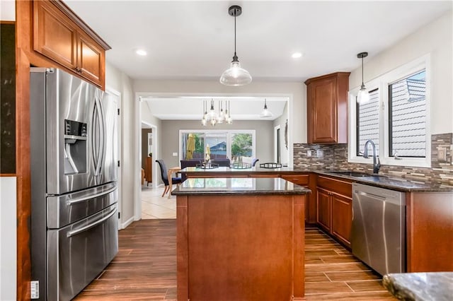 5490 W 85th Ter, Prairie Village, KS 66207 - kitchen featuring appliances with stainless steel finishes, tasteful backsplash, a center island, dark wood-style floors, and recessed lighting
