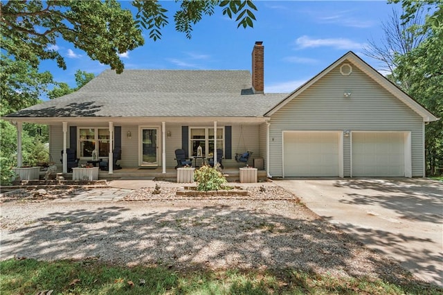 1684 Quarry Rd, Bates City, MO 64011 - view of front of home with a chimney, a garage, a porch, concrete driveway, and a shingled roof