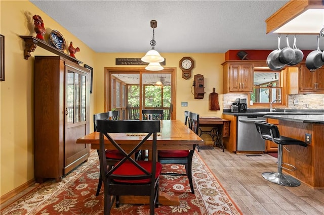 1684 Quarry Rd, Bates City, MO 64011 - dining area featuring light wood-style flooring and a textured ceiling