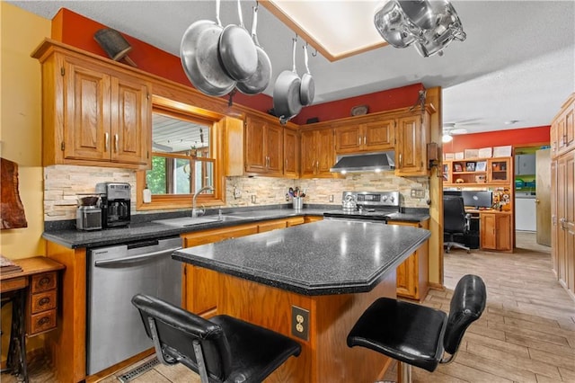 1684 Quarry Rd, Bates City, MO 64011 - kitchen featuring appliances with stainless steel finishes, a kitchen island, tasteful backsplash, a kitchen breakfast bar, and light wood finished floors