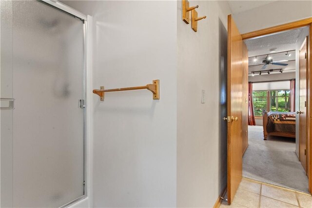 1684 Quarry Rd, Bates City, MO 64011 - bathroom with a stall shower, a textured ceiling, connected bathroom, and tile patterned flooring