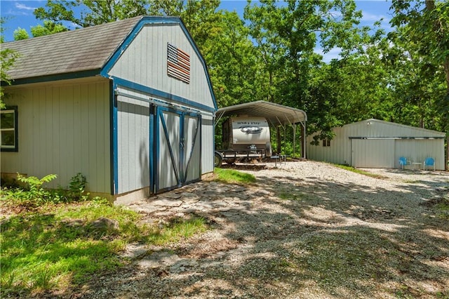 1684 Quarry Rd, Bates City, MO 64011 - view of outbuilding with a carport and driveway