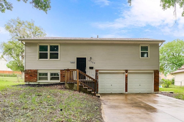 13309 Winchester Ave, Grandview, MO 64030 - raised ranch featuring a garage, brick siding, and driveway