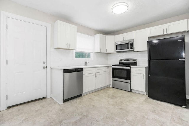 13309 Winchester Ave, Grandview, MO 64030 - kitchen with appliances with stainless steel finishes, white cabinetry, light countertops, and light flooring