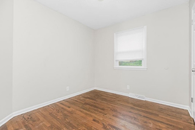 13309 Winchester Ave, Grandview, MO 64030 - empty room featuring baseboards and dark wood finished floors