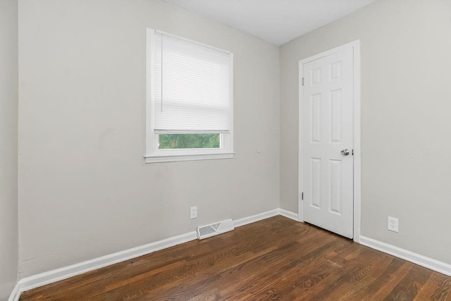 13309 Winchester Ave, Grandview, MO 64030 - unfurnished room featuring dark wood-style flooring and baseboards