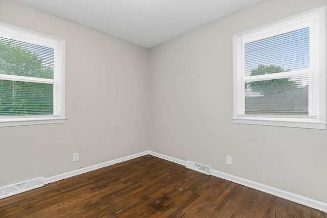 13309 Winchester Ave, Grandview, MO 64030 - spare room featuring baseboards and dark wood-style floors