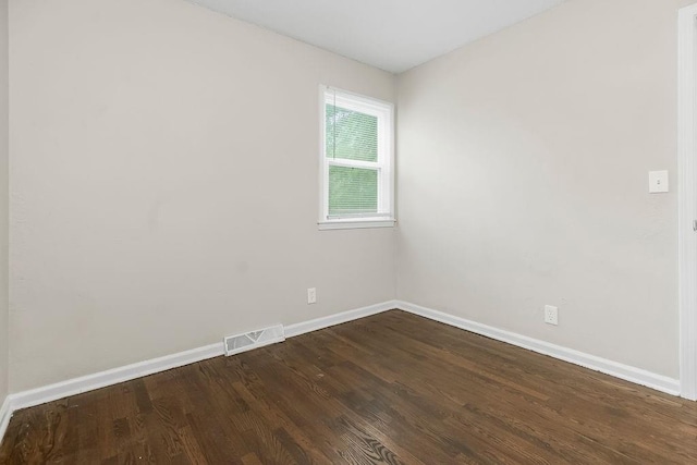 13309 Winchester Ave, Grandview, MO 64030 - empty room featuring baseboards and dark wood finished floors