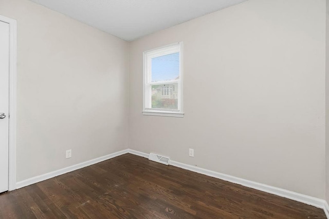 13309 Winchester Ave, Grandview, MO 64030 - spare room featuring baseboards and dark wood-style floors