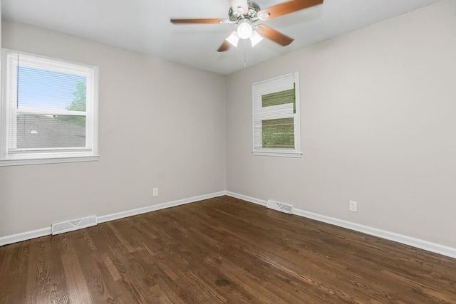 13309 Winchester Ave, Grandview, MO 64030 - unfurnished room with healthy amount of natural light, dark wood finished floors, and ceiling fan