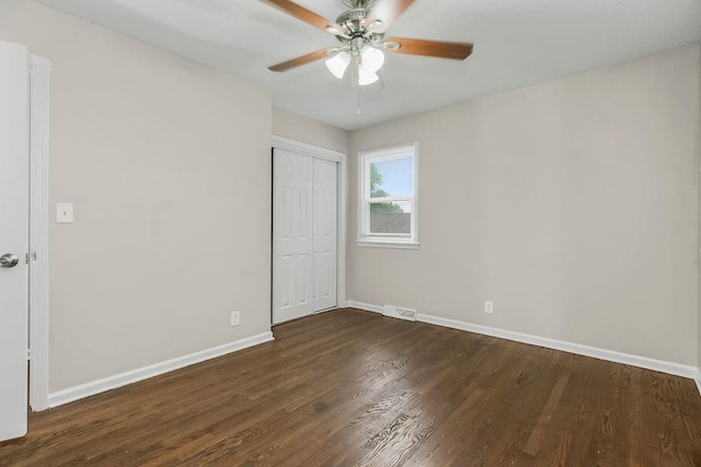 13309 Winchester Ave, Grandview, MO 64030 - unfurnished bedroom with dark wood finished floors, a closet, and a ceiling fan