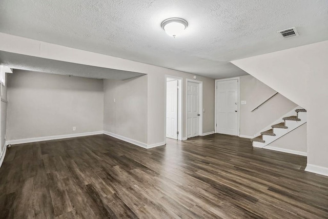 13309 Winchester Ave, Grandview, MO 64030 - finished below grade area featuring a textured ceiling, dark wood-style floors, and stairway