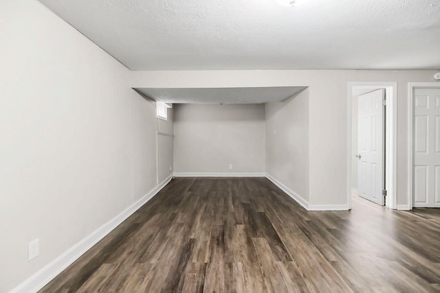 13309 Winchester Ave, Grandview, MO 64030 - finished below grade area featuring dark wood-style floors and baseboards