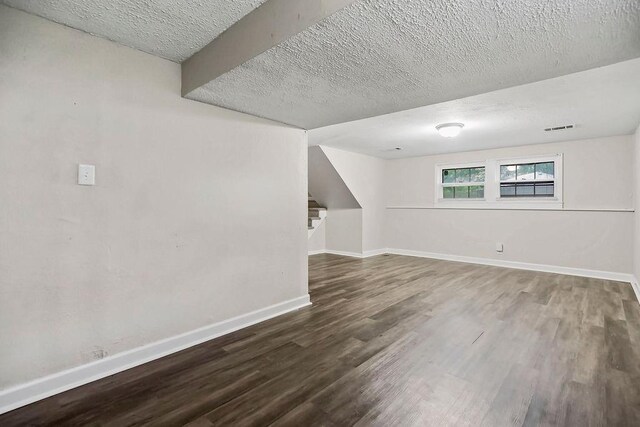 13309 Winchester Ave, Grandview, MO 64030 - below grade area with wood finished floors and a textured ceiling