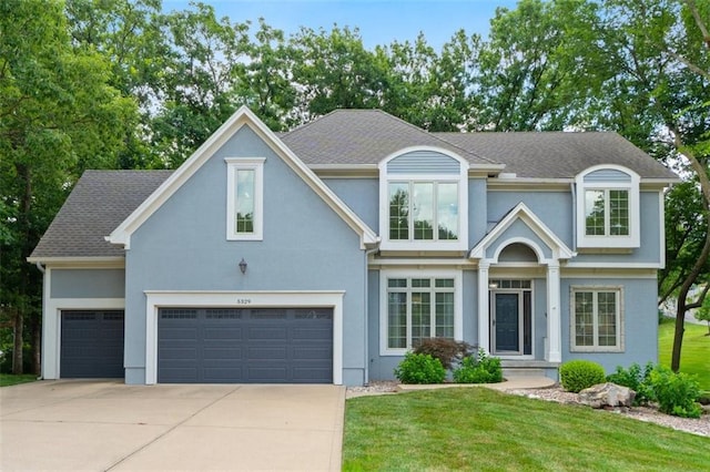 5329 Park St, Shawnee, KS 66216 - view of front of house with driveway, stucco siding, and a front lawn