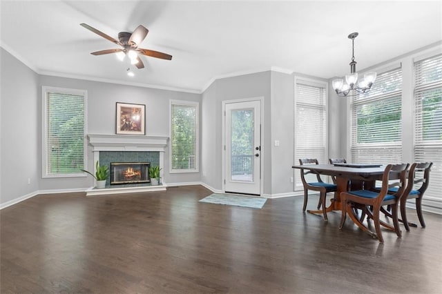 5329 Park St, Shawnee, KS 66216 - dining room featuring a chandelier, dark wood-style floors, ornamental molding, ceiling fan, and a tiled fireplace