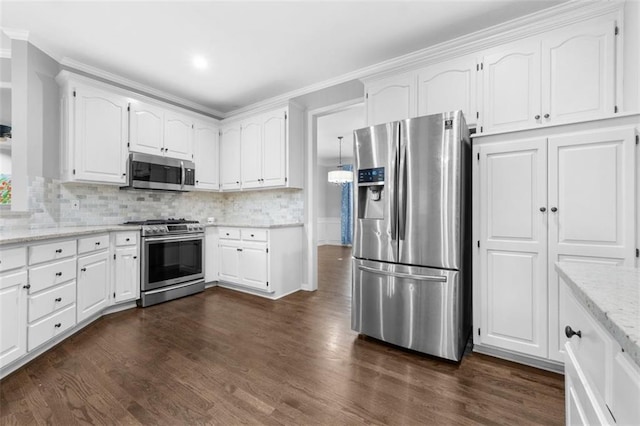 5329 Park St, Shawnee, KS 66216 - kitchen featuring stainless steel appliances, crown molding, dark wood-style floors, white cabinets, and backsplash