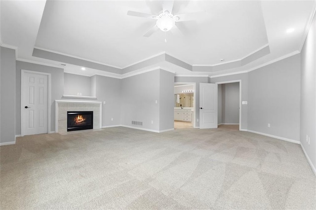 5329 Park St, Shawnee, KS 66216 - unfurnished living room featuring a tray ceiling, ceiling fan, light carpet, crown molding, and a fireplace