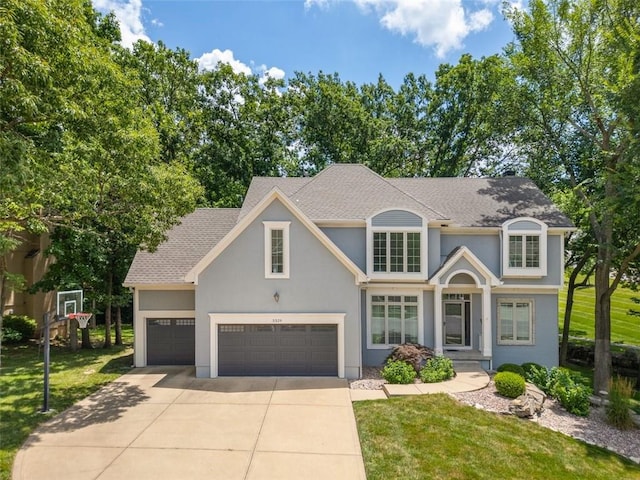 5329 Park St, Shawnee, KS 66216 - traditional-style home featuring concrete driveway, stucco siding, a front yard, a shingled roof, and a garage