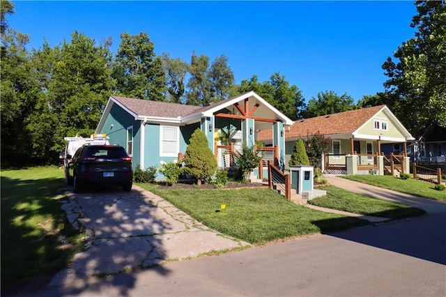 2725 N 20th St, Kansas City, KS 66104 - view of front of property with driveway, a front lawn, covered porch, and stucco siding