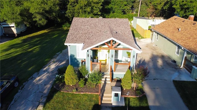 2725 N 20th St, Kansas City, KS 66104 - bungalow-style house with stairs, a shingled roof, concrete driveway, and a front yard