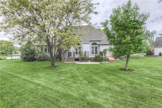 15733 Pine Cir, Basehor, KS 66007 - back of house featuring a deck, a shingled roof, and a lawn