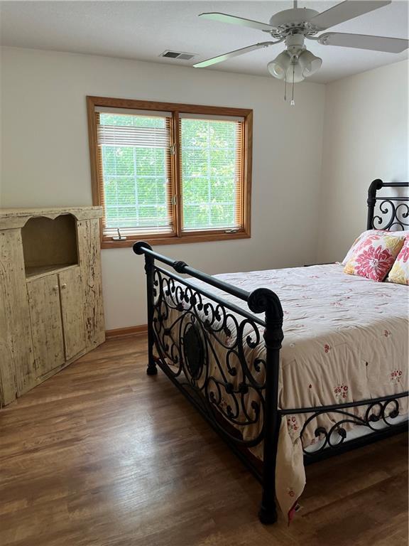 15733 Pine Cir, Basehor, KS 66007 - bedroom featuring wood finished floors and ceiling fan