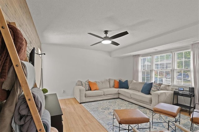 9410 Taylor Dr, Overland Park, KS 66212 - living area featuring wood finished floors, a ceiling fan, and a textured ceiling