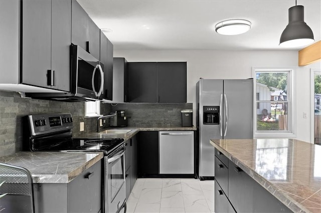 9410 Taylor Dr, Overland Park, KS 66212 - kitchen with stainless steel appliances, light marble finish flooring, backsplash, pendant lighting, and dark cabinets