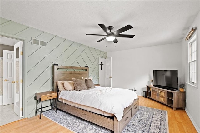 9410 Taylor Dr, Overland Park, KS 66212 - bedroom featuring light wood-style floors, a textured ceiling, and ceiling fan