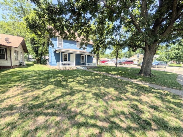 712 N Jefferson Ave, Iola, KS 66749 - view of green lawn featuring covered porch