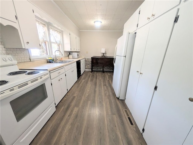 712 N Jefferson Ave, Iola, KS 66749 - kitchen with white appliances, dark wood-style floors, ornamental molding, decorative backsplash, and white cabinets
