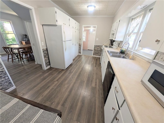 712 N Jefferson Ave, Iola, KS 66749 - kitchen featuring white appliances, white cabinetry, dark wood-type flooring, light countertops, and crown molding
