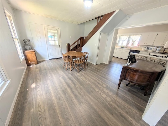 712 N Jefferson Ave, Iola, KS 66749 - dining area with stairway and wood finished floors