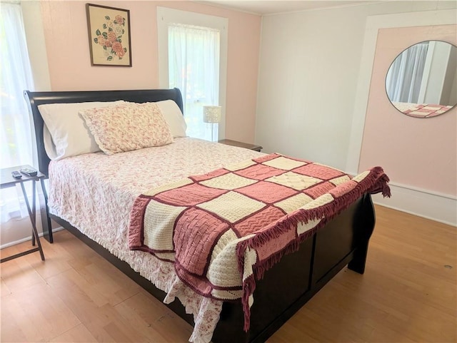 712 N Jefferson Ave, Iola, KS 66749 - bedroom with wood finished floors